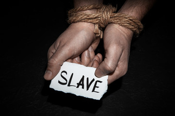 Tied hands with rope in man. The concept of slavery or hostage, restriction of freedom.