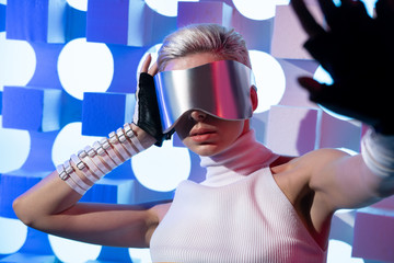 blonde with glasses of virtual reality stretched her hand forward