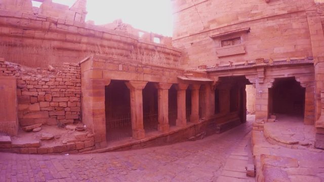 Half destroied walls of Golden Fort inside street with columns yellow sandstone