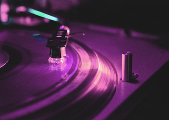 Dj playing and mixes track on Player at night club party