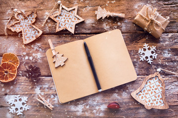 Christmas wish list on a wooden background and Christmas decorations