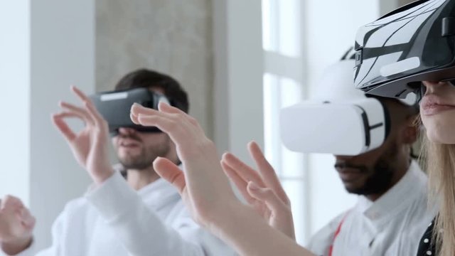 Creation of applications or programs for virtual and augmented reality. Designers developers work in the office in VR glasses. Creative business team in modern office. Augmented reality AR. Innovation