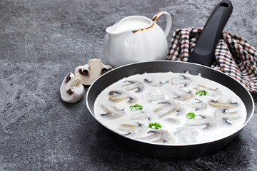 Mushroom cream sauce in a pan on a gray table