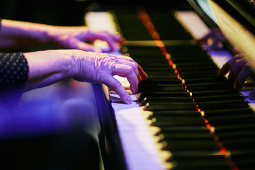 older hands playing piano © maxwellmonty