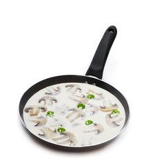 Mushroom cream sauce in a pan isolated on white