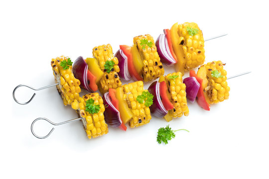 Delicious skewers with grilled corn and pepper isolated on white