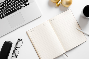 Christmas home office desk with computer, christmas balls golden decorations flat lay top view