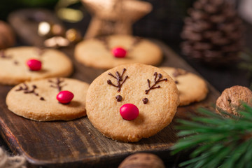 Homemade deer cookies decorated chocolate and red candies Soft focus Greeting card