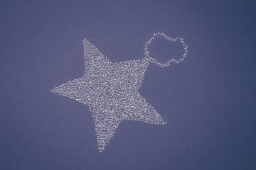 Star decoration made of sparkling beads on blue background.