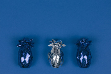 Shining blue and silver Christmas ornament lined on blue background.