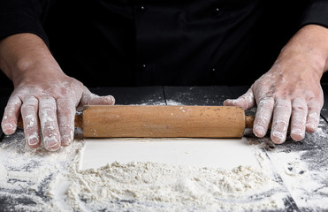 wooden rolling pin in male hands
