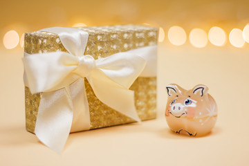 Symbol of the year with a golden present box on the bokeh lights background.