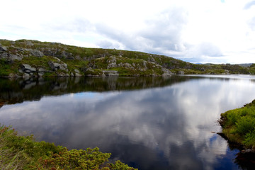 Fototapeta na wymiar lake with reflection on top of a mountain