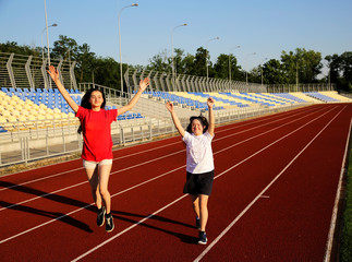 Little girl running on the stadium