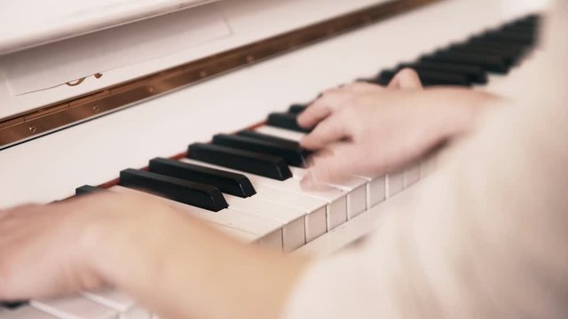 Woman play the white piano