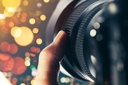 Photographer using zoom lens on DSLR camera