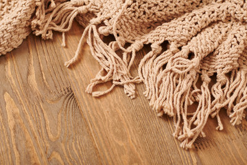 brown knitted blanket on wooden background