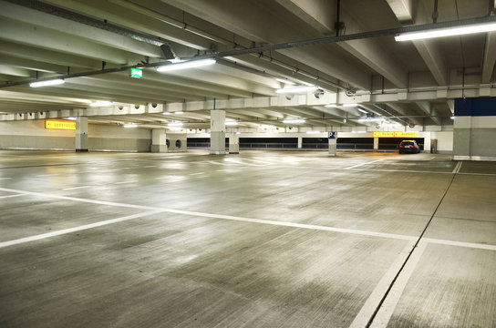 Einzelnes Auto in leerem Parkhaus – Single car in a parking deck 
