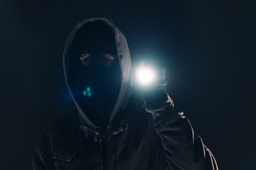 Burglar intruder with flashlight torch at night