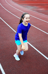 Fototapeta premium Little girl have fun on the stadium