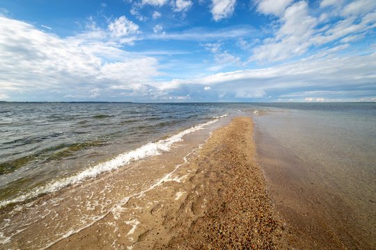 Landscape with a promontory, sea and blue sky.