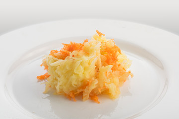Grated carrots and chopped apple on white plate