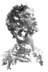 Double exposure in black and white of a young sexy man’s portrait blended with branches of a...