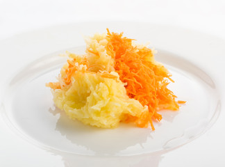 Grated carrots and chopped apple on white plate