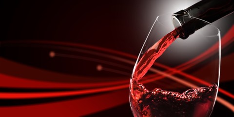 Red wine pouring in glass on  background