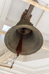 Obraz premium Church bronze bell Ukrainian Orthodox Church of the Moscow Patriarch. The inscription on the bell: Holy Assumption Odessa Patriarchal Monastery, the phrase from the Bible