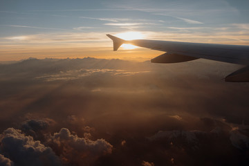 Fototapeta na wymiar Winglet of an airplane above the alps on sunset