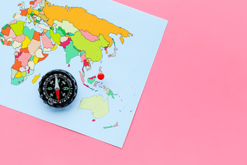Direction concept with compass and map on pink background top view mockup