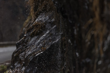 Drops and splashes of a mountain waterfall with beautiful bokeh