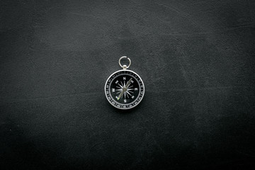 direction and movement concept with compass on black background top view mock up © 9dreamstudio