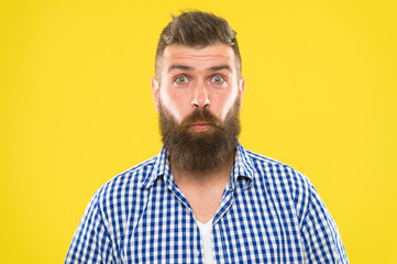 Obraz premium Burst of laughter. Hipster with beard and mustache emotional surprised expression. Rustic surprised macho. Man bearded hipster wondering face yellow background close up. Guy surprised face expression