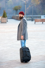 Hipster ready enjoy travel. Carry travel bag. Man bearded hipster travel with luggage bag on...