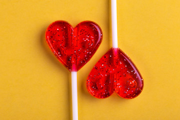 Two red sweet tasty lollipops in shape of heart