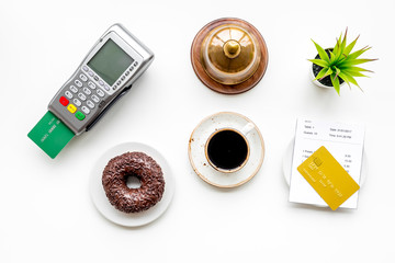 Electronic payments. Pay the bill by card concept. Bank card inserted in payment terminal near...