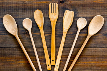 Village wooden cutlery set on wooden background top view