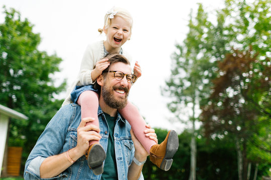 Father giving daughter piggyback ride