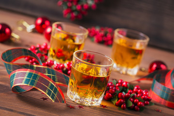 Whiskey, brandy or liquor shot and Christmas decorations