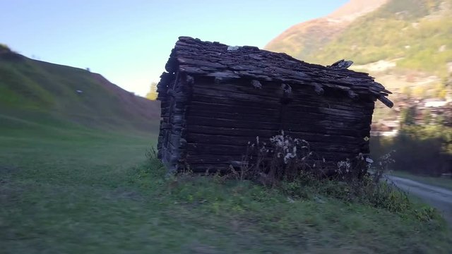 Rural Swiss Alps village with wooden barns