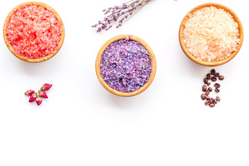 Colorful bath salt pink and violet on white background top view copy space