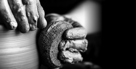 Hands of potter making clay pot, closeup photo