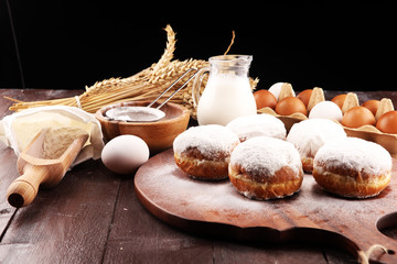 german donuts or berliner with ingredient on rustic background