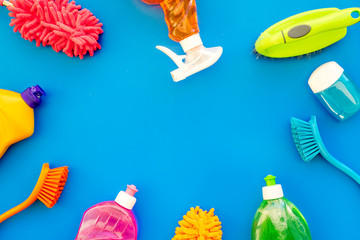Housekeeping set. Detergents, soap, cleaners and brush for housecleaning on blue background top view mock-up