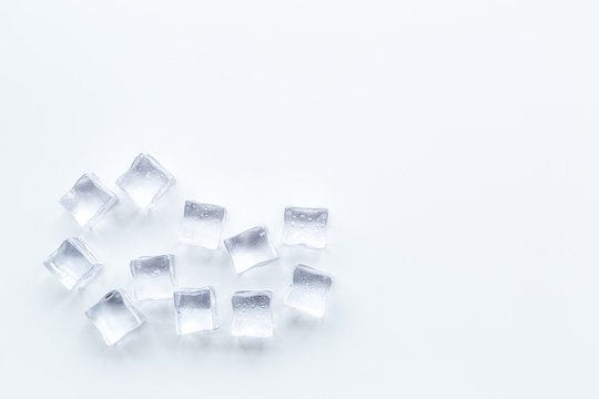 pile of ice cubes on white bar table top view mock-up
