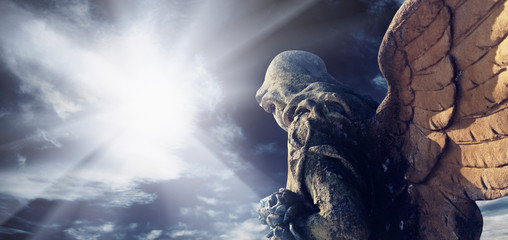 Antique statue of wonderful angel in the rays of the sun. Architecture, archetype, religion, faith...