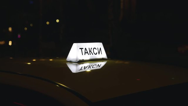Cyrillic Taxi Cab Sign Light at Night
