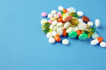 Assortment of pills, tablets and capsules on table